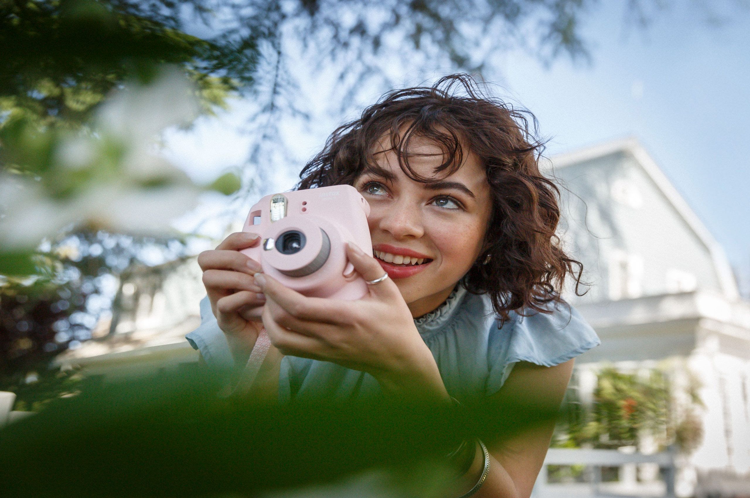 Young Woman Holding Polaroid Camera