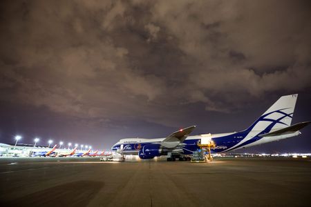 Wide side view of a Boeing 747-8 Freighter at an airport, with the left side cargo door open, being unloaded and then being re loaded with cargo at night time. Next stop, the other side of the world! A project shooting for the air cargo industry. This project was amazing as an industrial photographer, on location photographer & location commercial photographer.
Shallow depth of field and selective focus. Environmental portraits Wide Side View of a 747 Cargo Plane