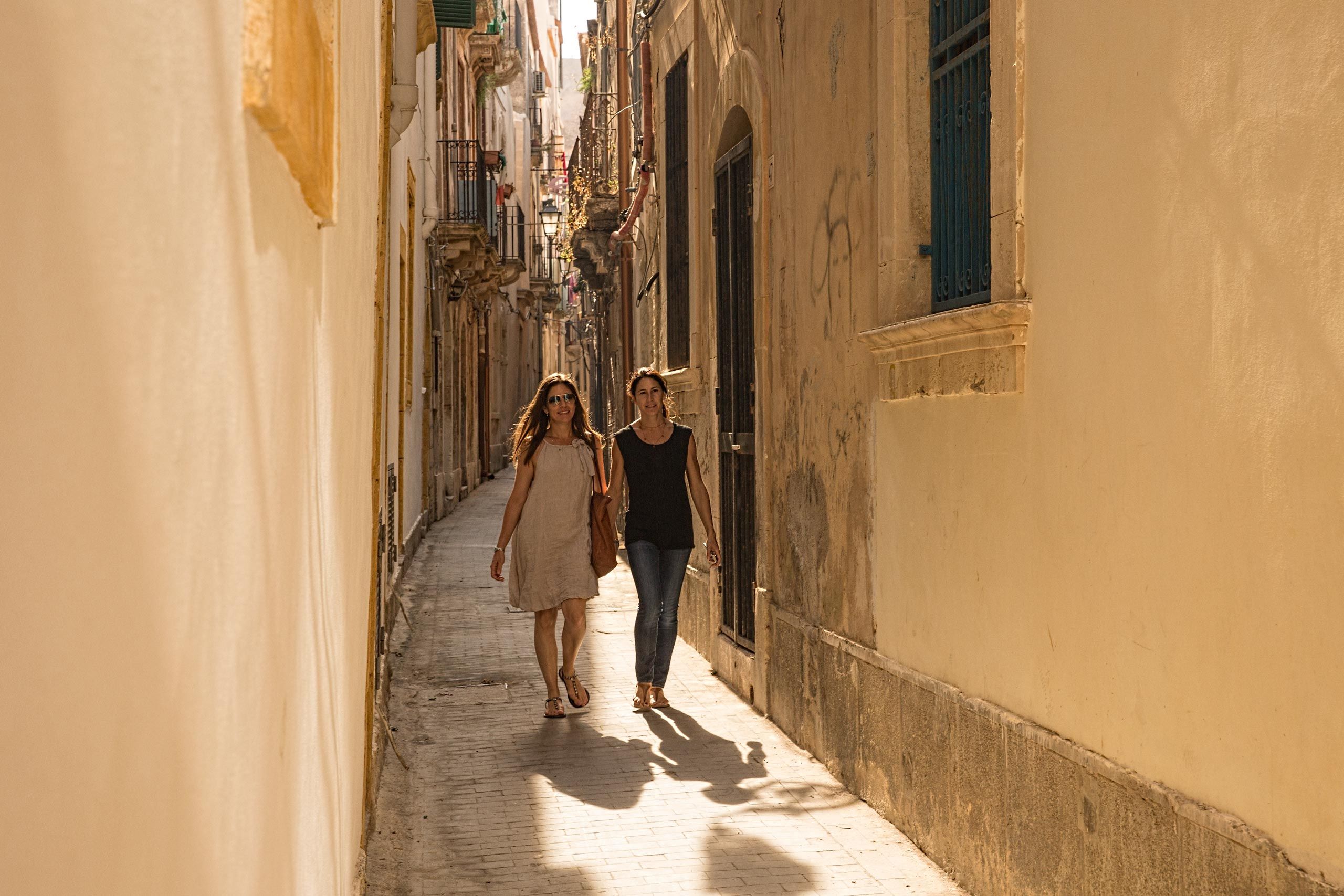 Lady's Walking in a Sun Drenched Backlit Alley