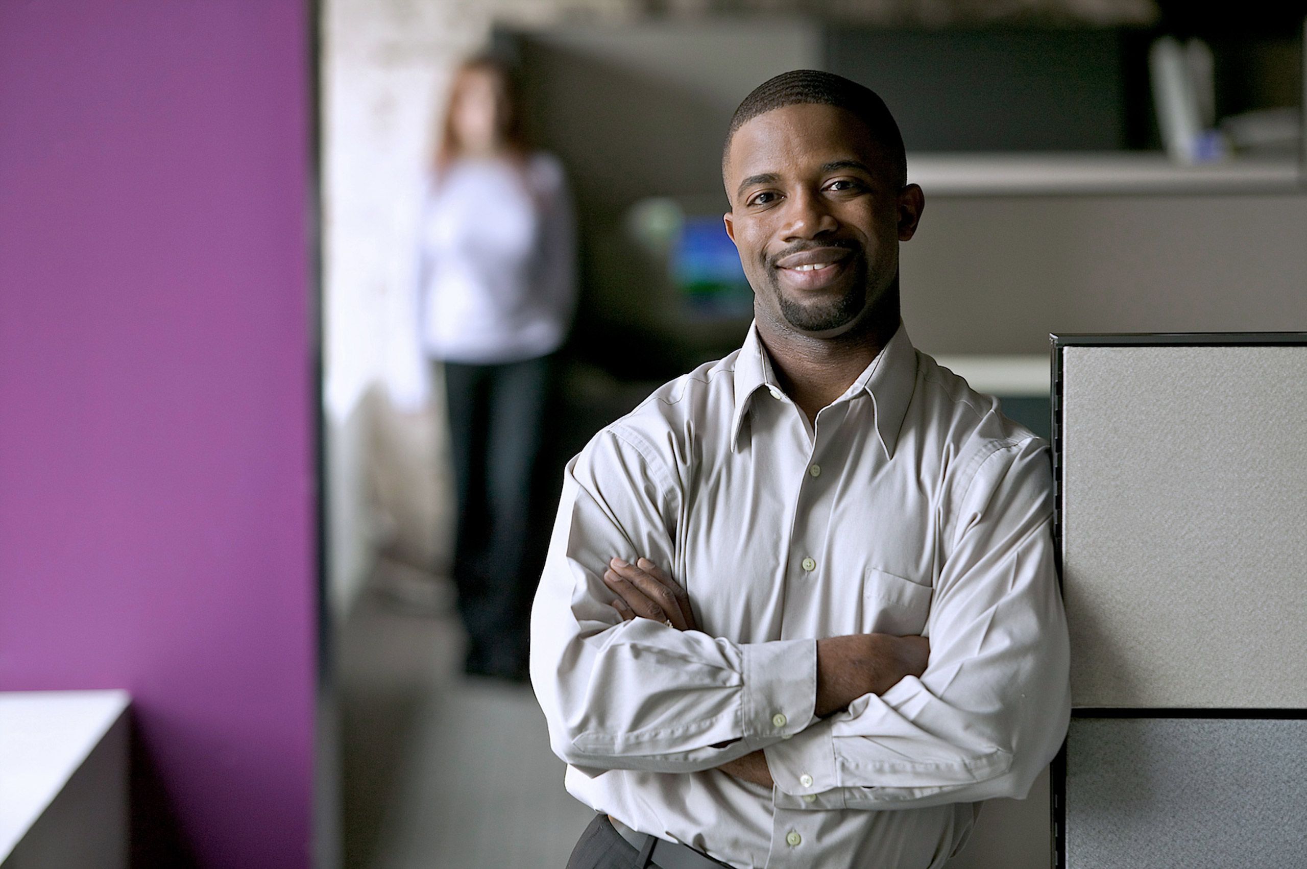Man Smiling Against Cubicle