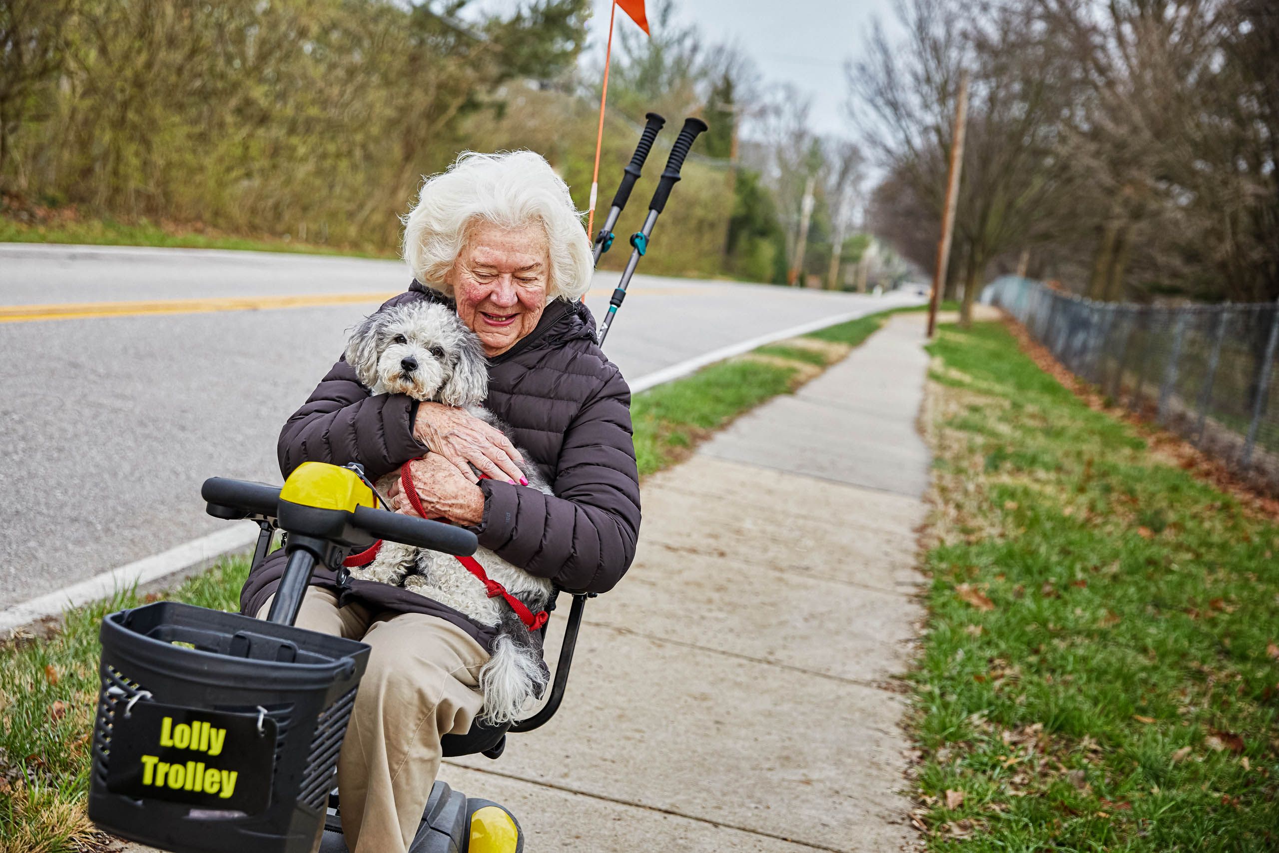 Old Woman Riding Scooter with Dog