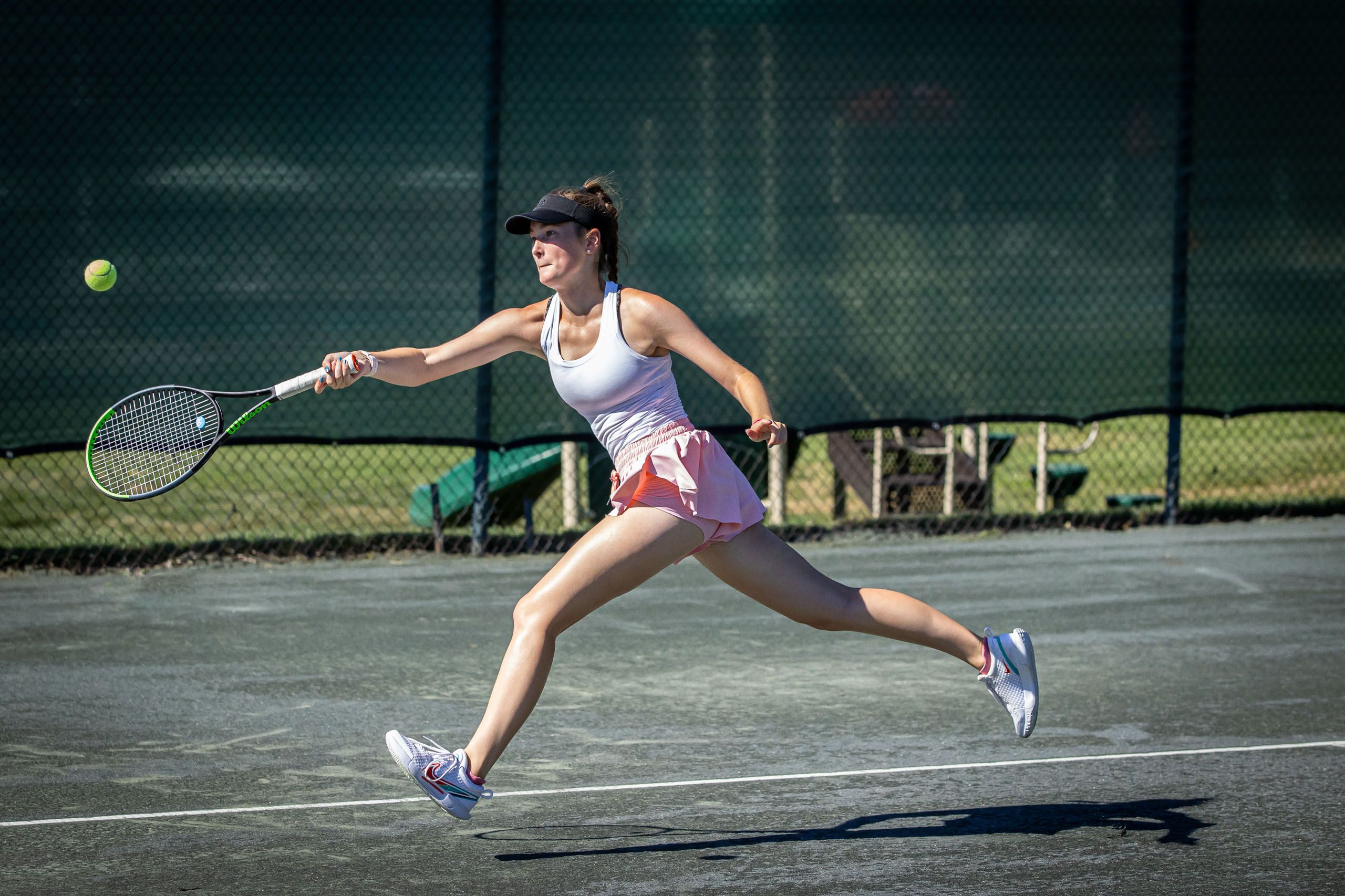 Woman Lunges for Tennis Ball