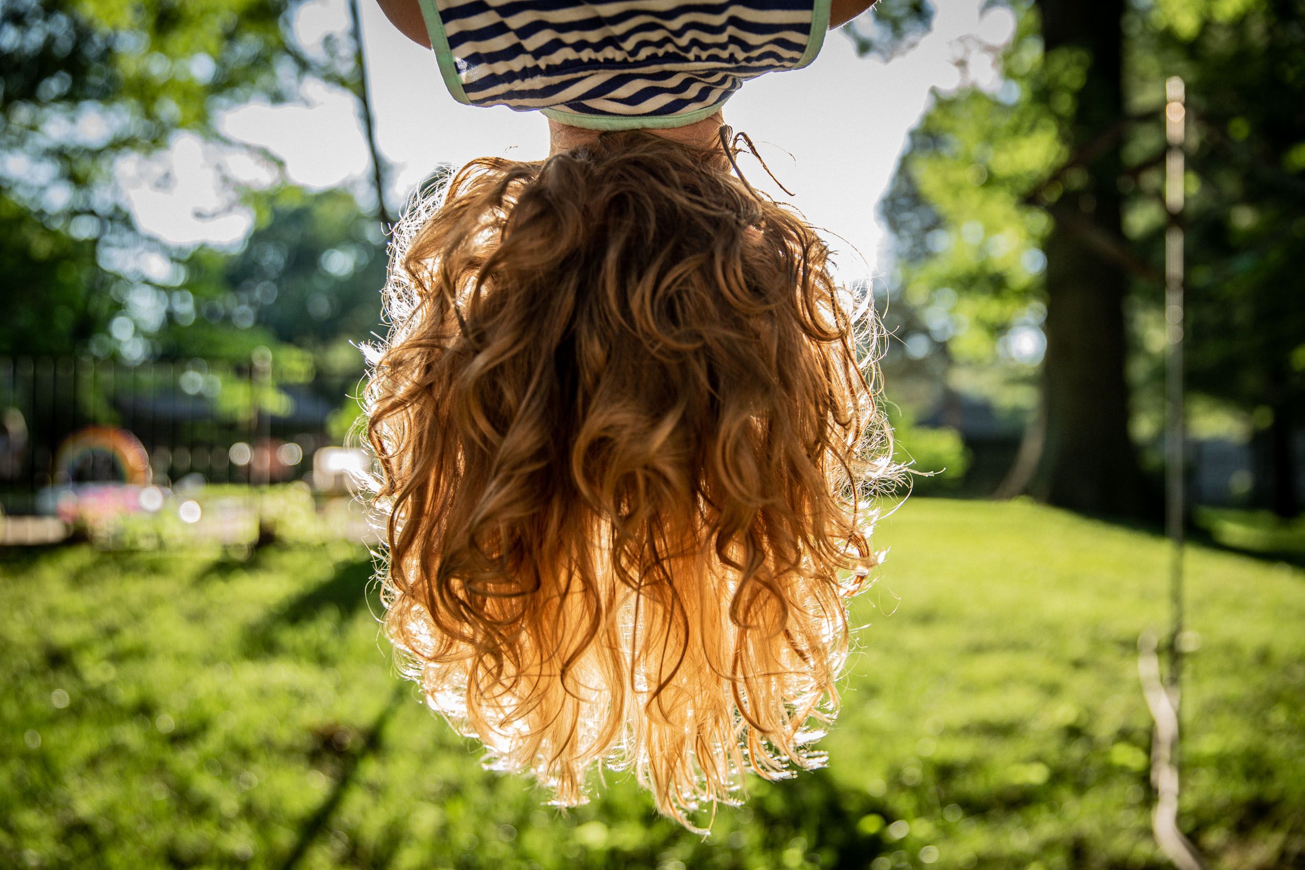 Young Girl Upside Down on Playground