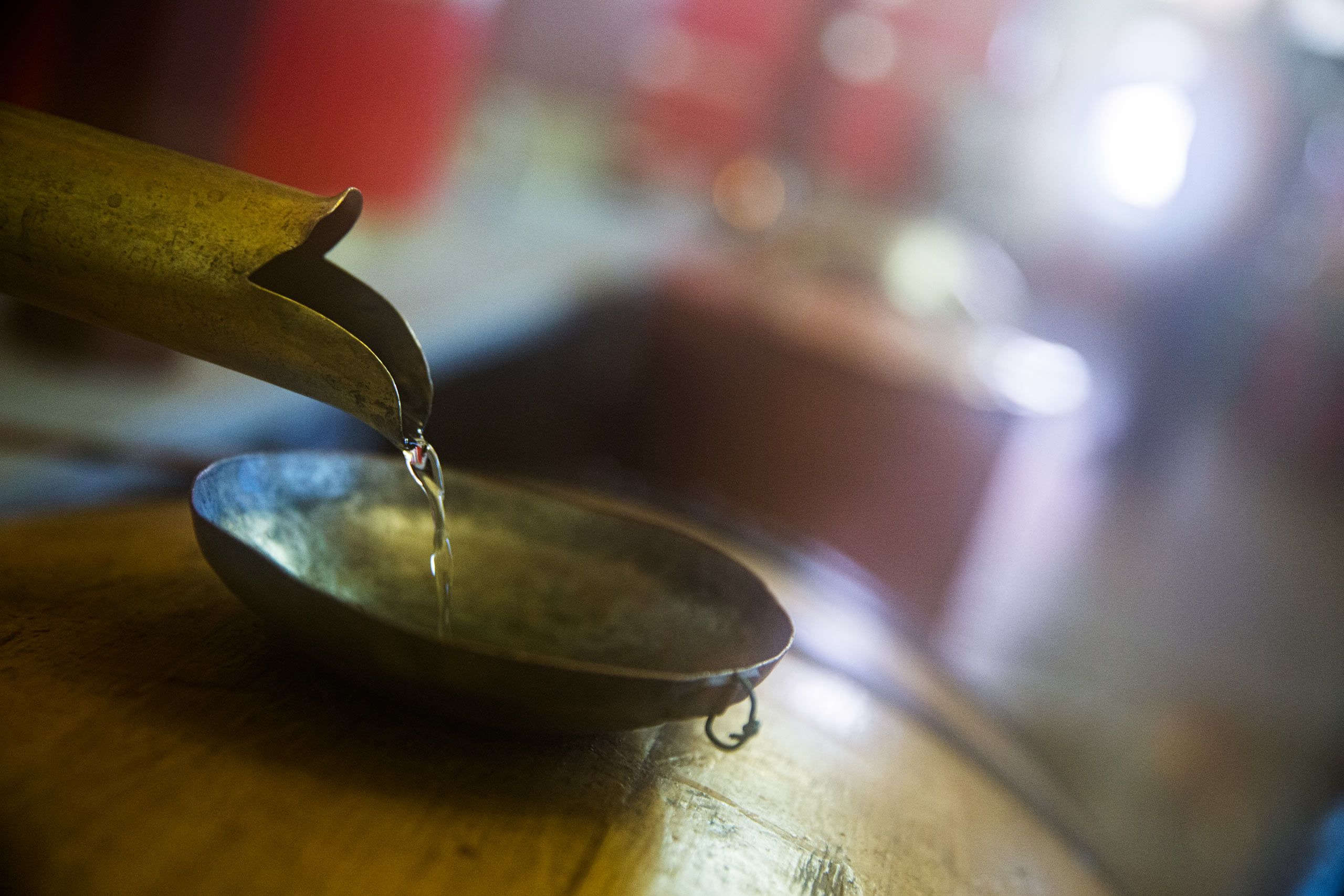 Absinthe Flowing into a Wooden Barrel