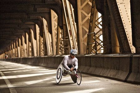 A very fit wheeler, paraplegic in a racing wheelchair racing in the NYC Marathon, on the Queensboro Bridge. Wheeler in a Bridge