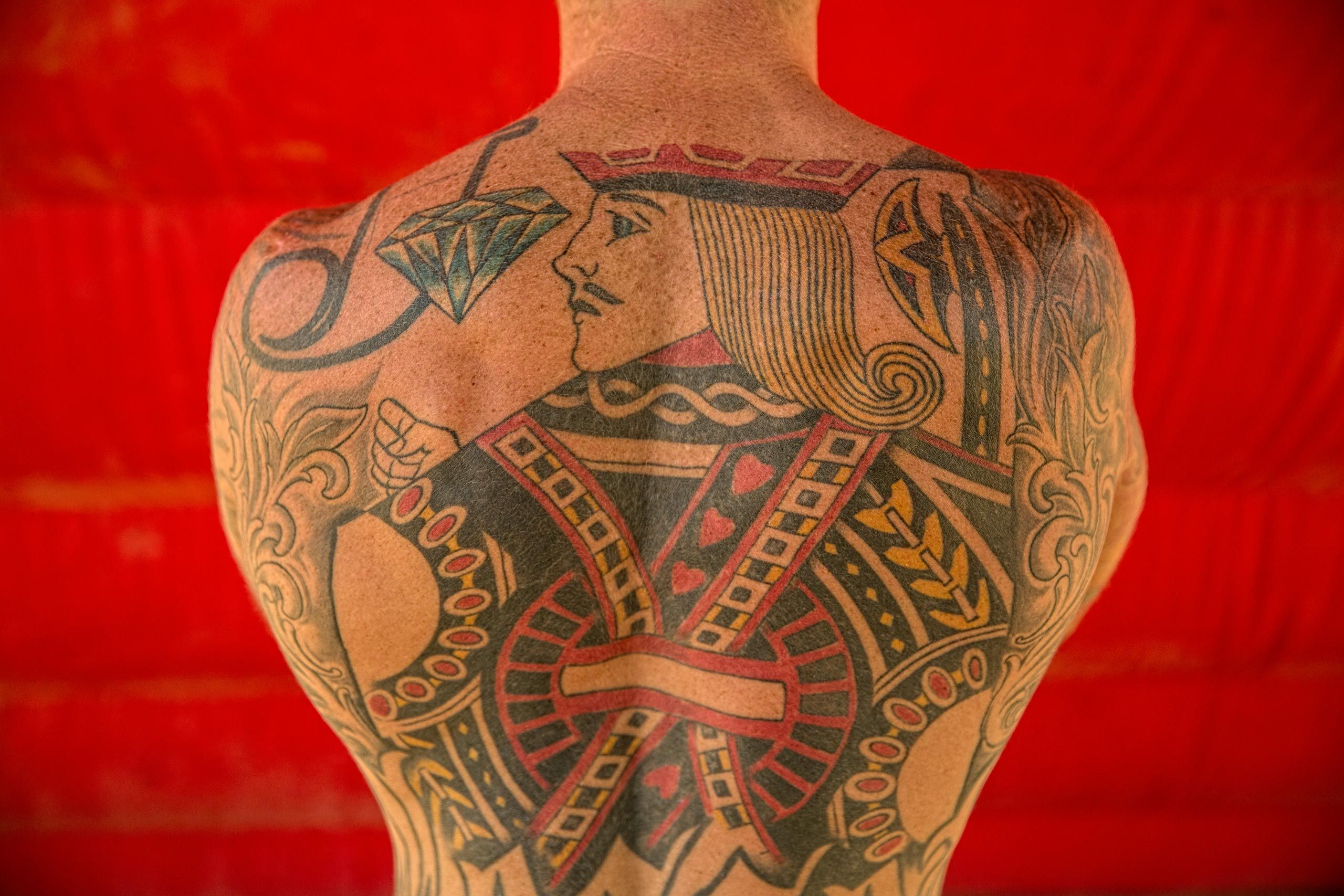 Portrait of a King of Hearts Tattoo on the Back of a Shirtless Man