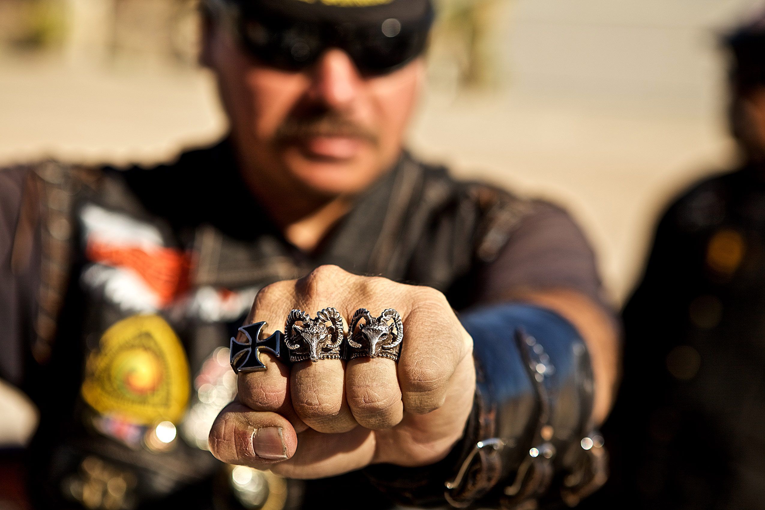 Man Showing his Fist of Rings