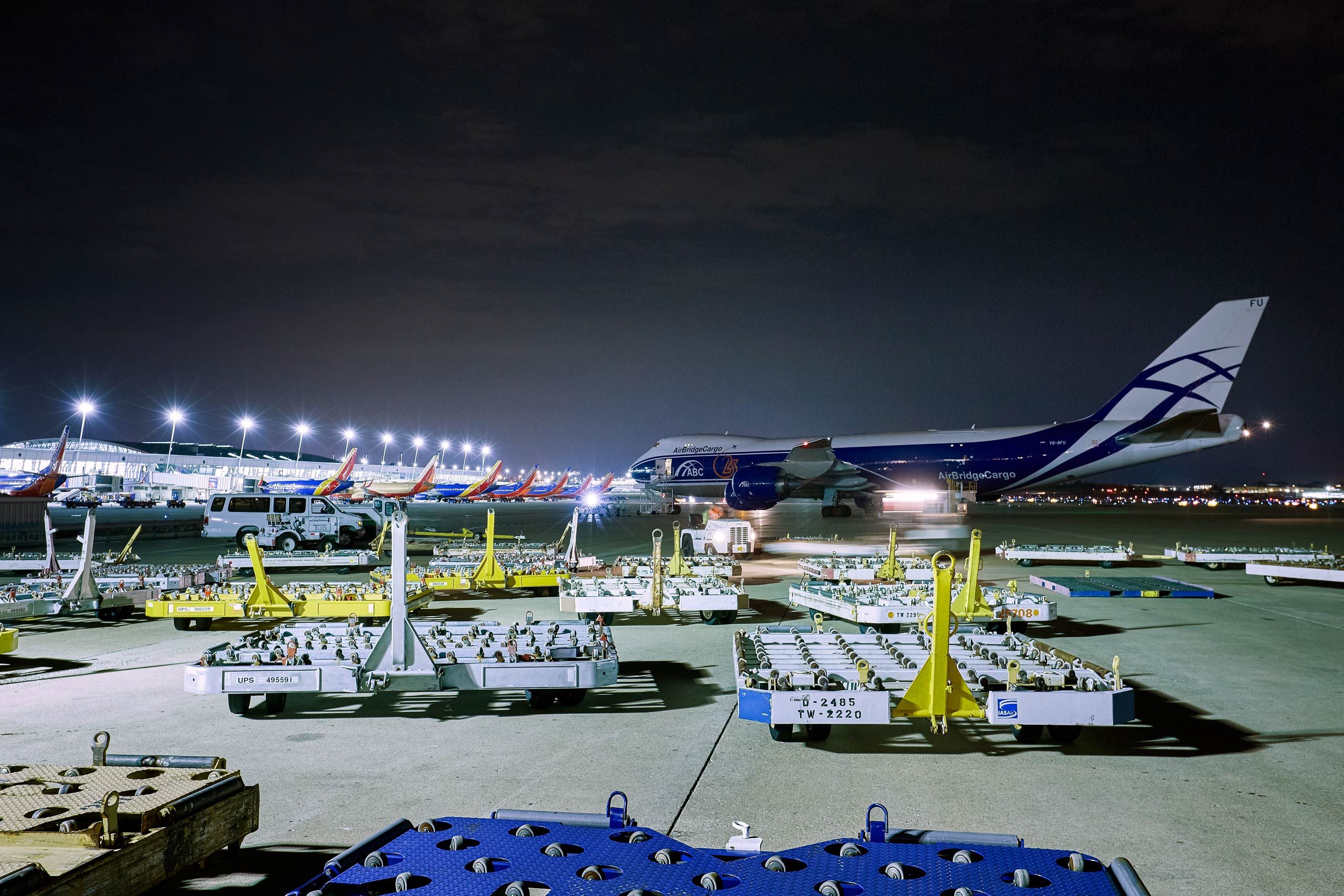 Wide View of a Boeing 747 Aircraft With Empty Cargo Handling Equipment in the Foreground