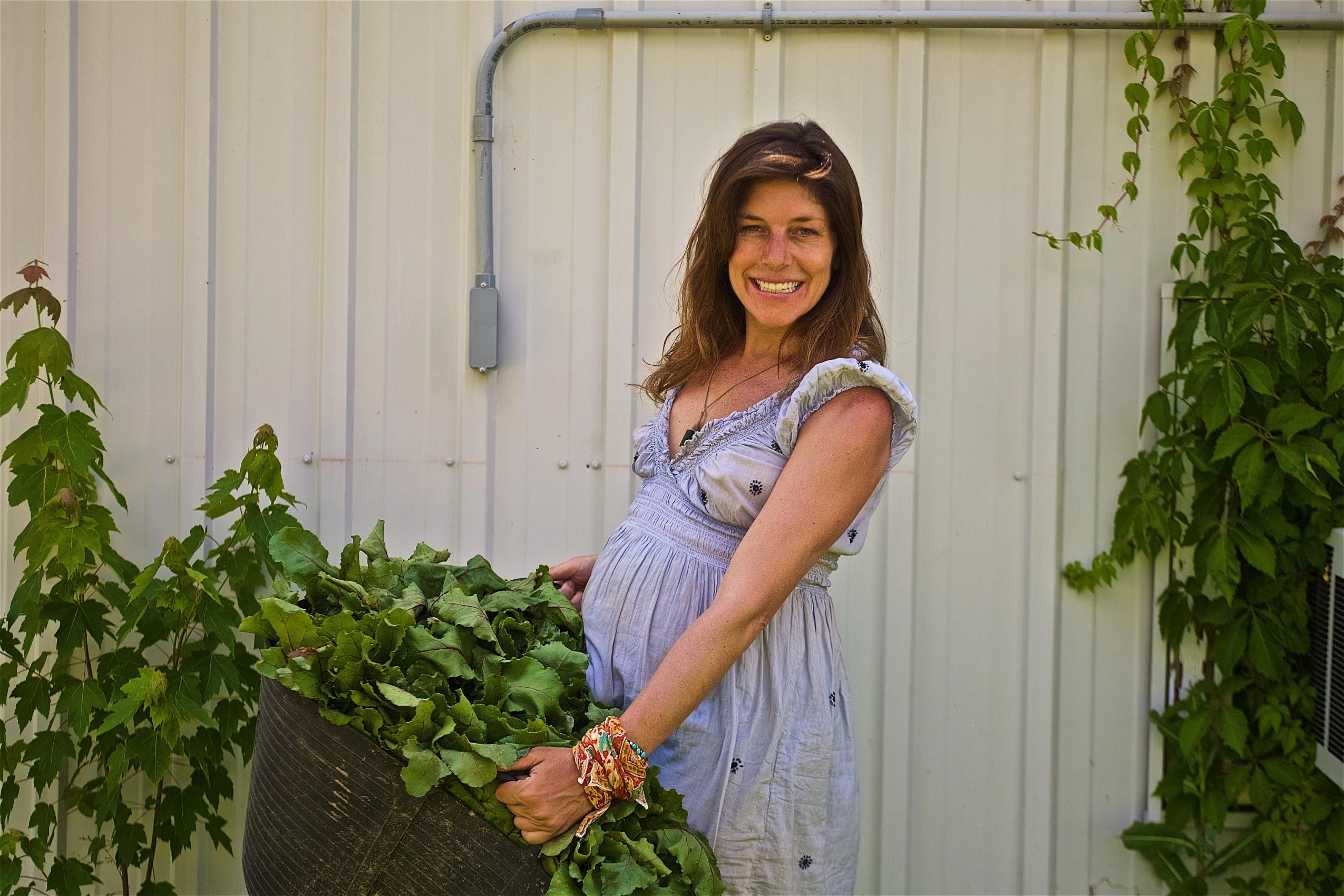 Pregnant Woman Holding a Bushel of Vegetables