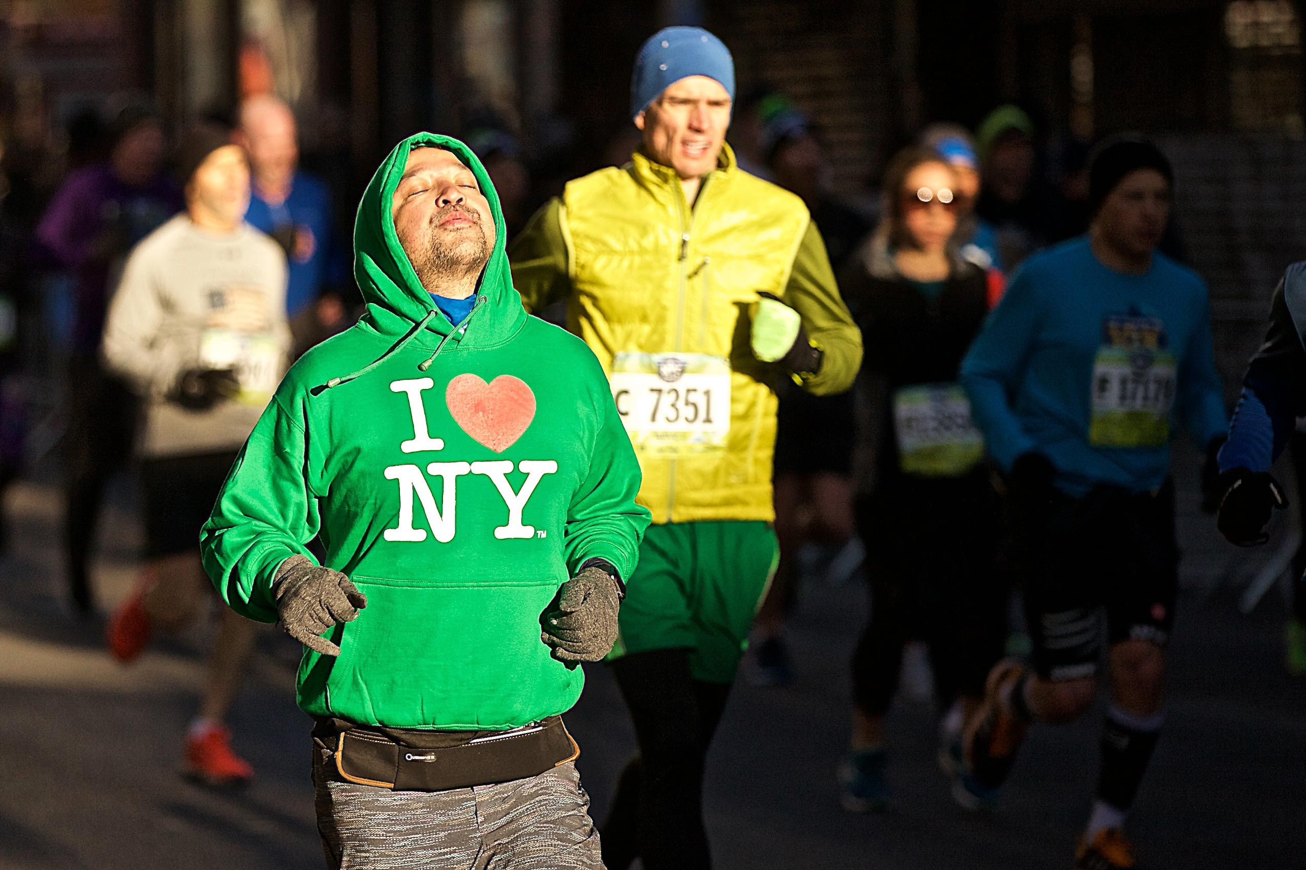 Man Running NYC Half Marathon in Chinatown.