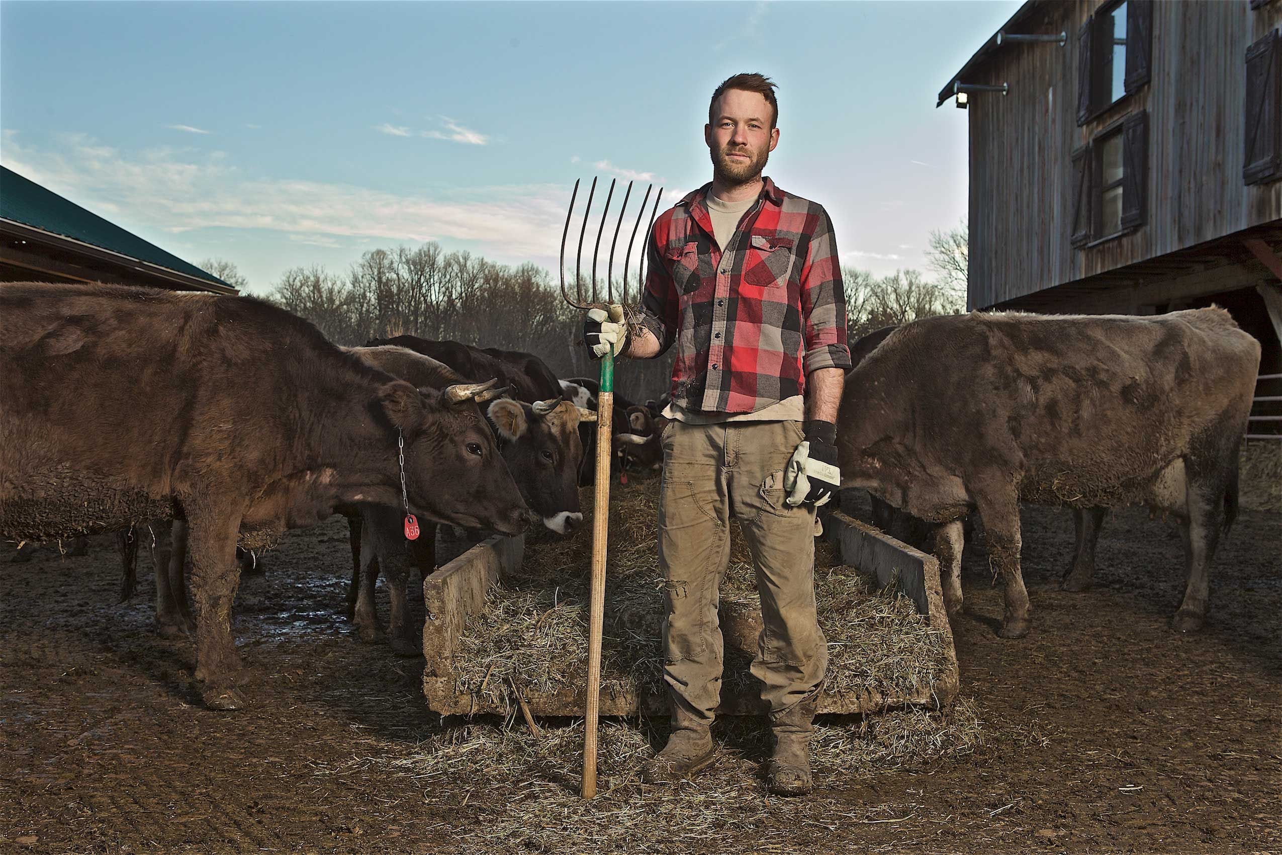 Farmer Standing Holding a Pitch Fork