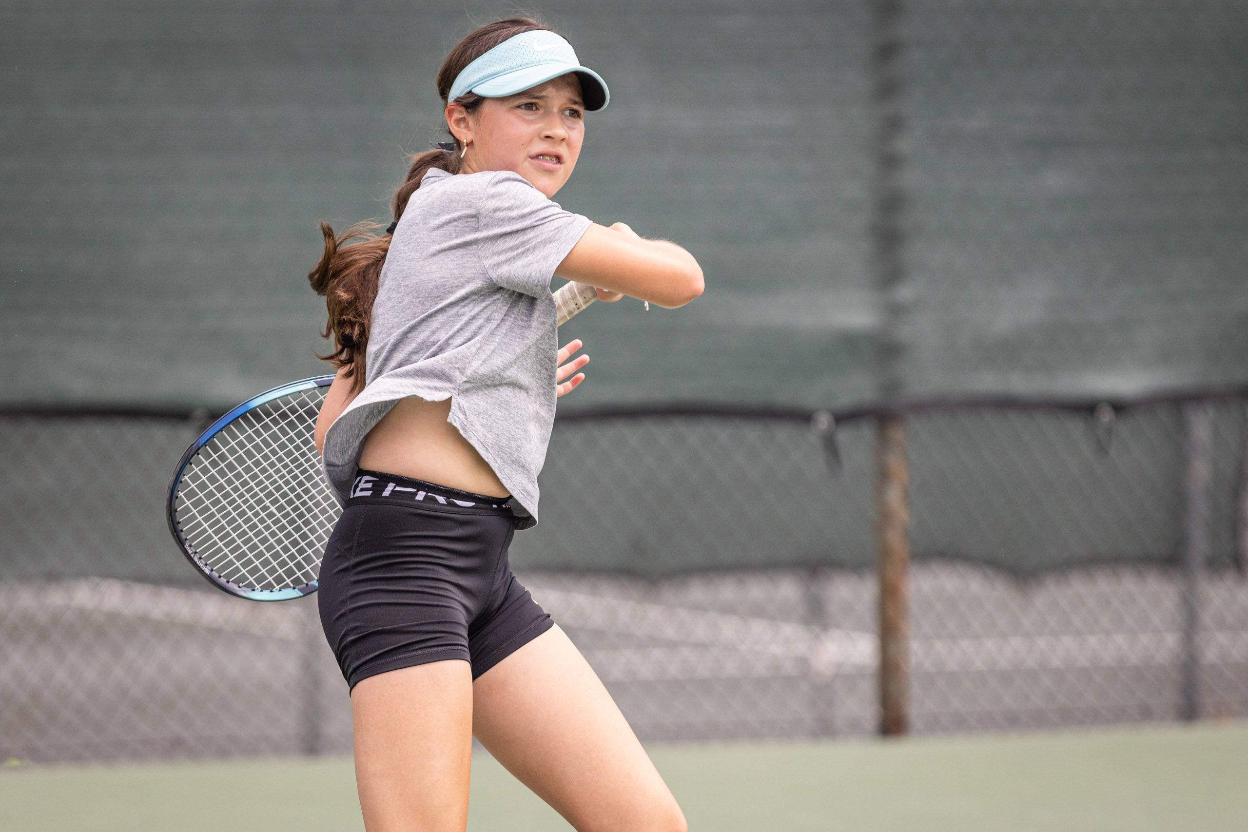 Teenage girl playing tennis