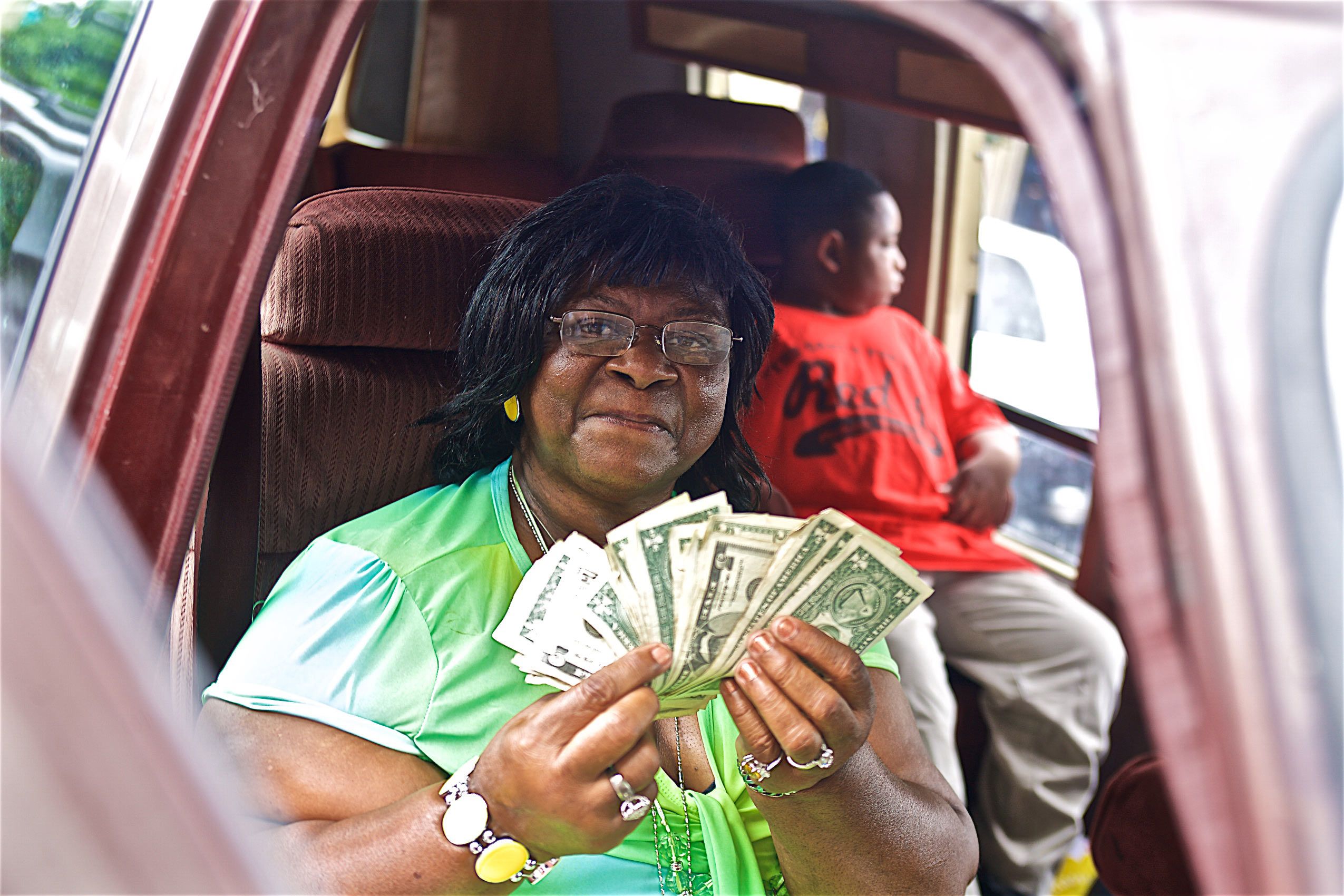 Wife of T Model Ford Holding Dollars