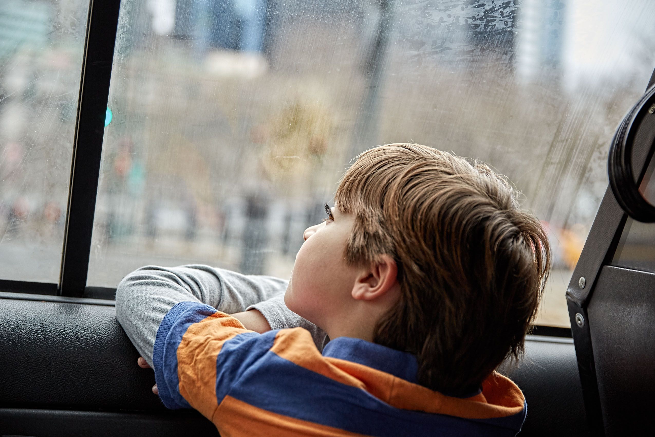 Boy Looking Out Car Window