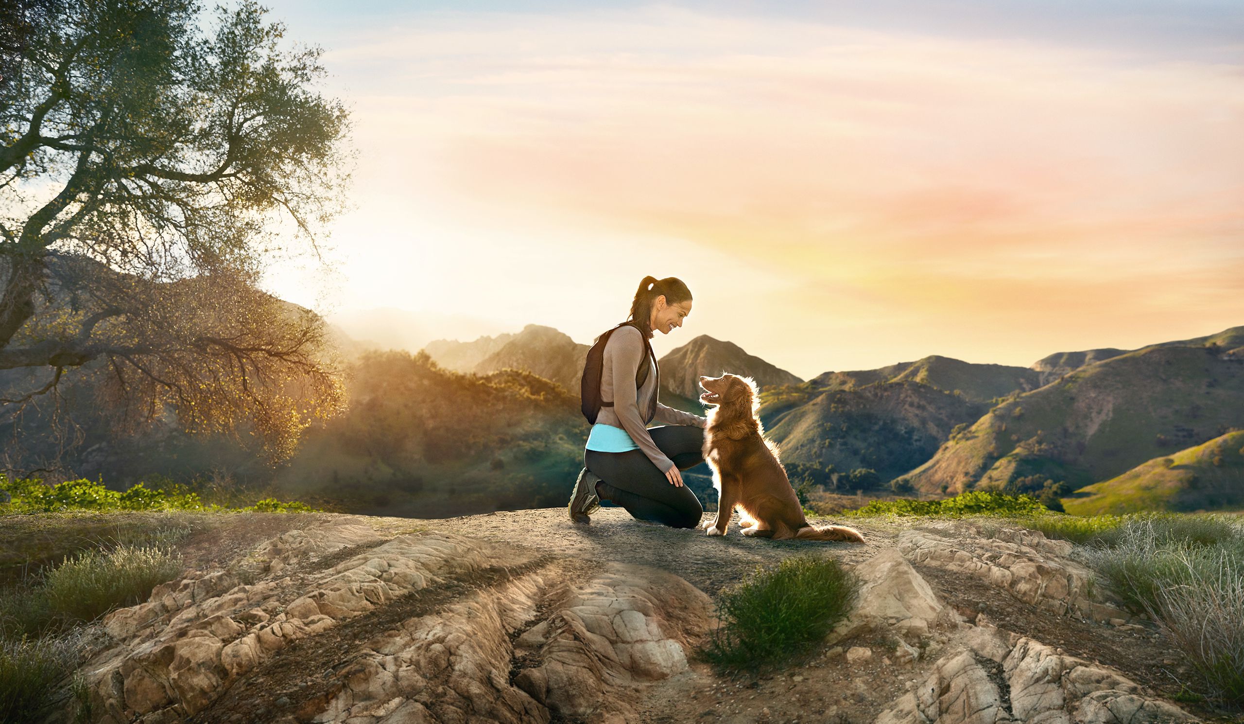 Young Woman Hiking With Dog