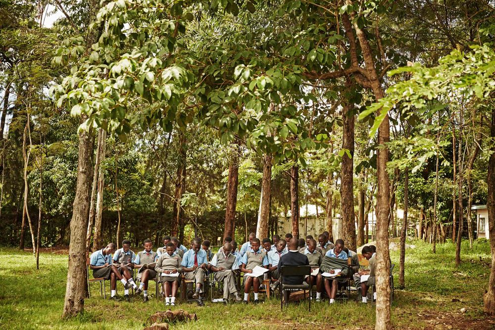 Wide shot of secondary school kids studying at school in an outdoor classroom. Outdoor Classroom Wide.jpg