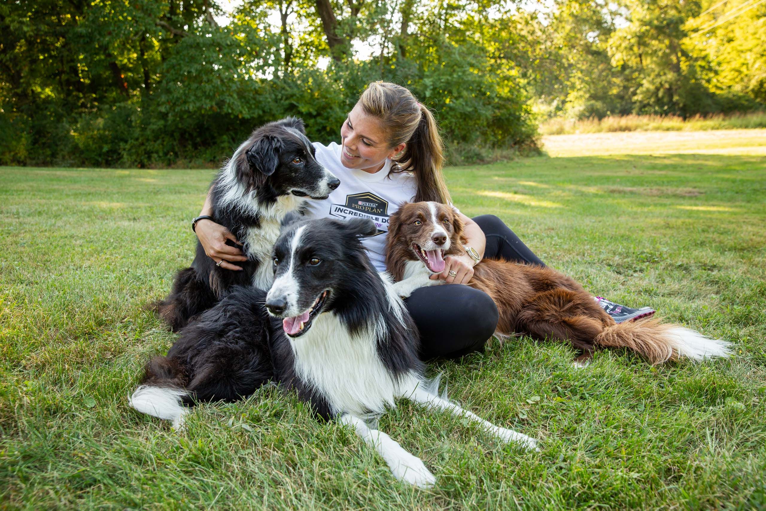 Woman Smiling with Three Dogs