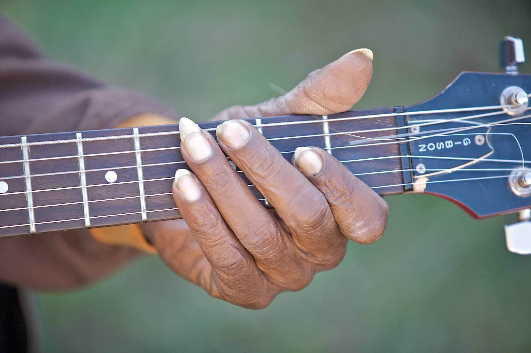 RL Boyce Hand on a Neck of a Guitar