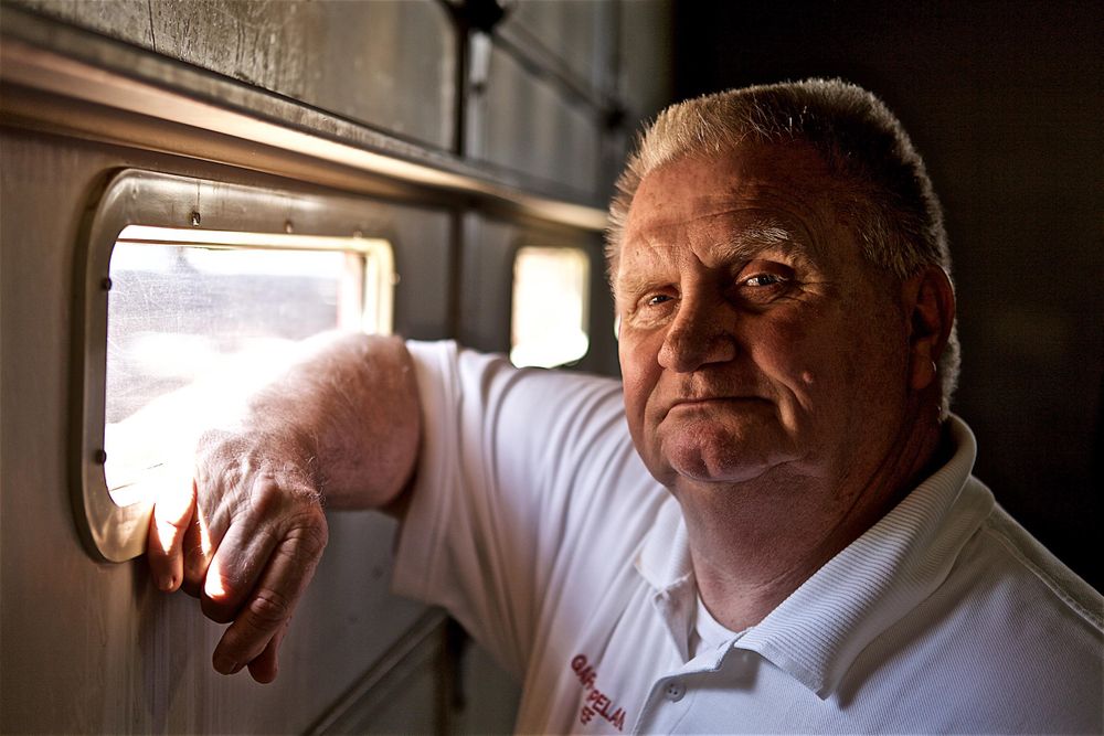 A portrait of a man, a fireman, using just window light at the fire house. He is looking confident and secure and looking into the camera. Portrait in Window Light