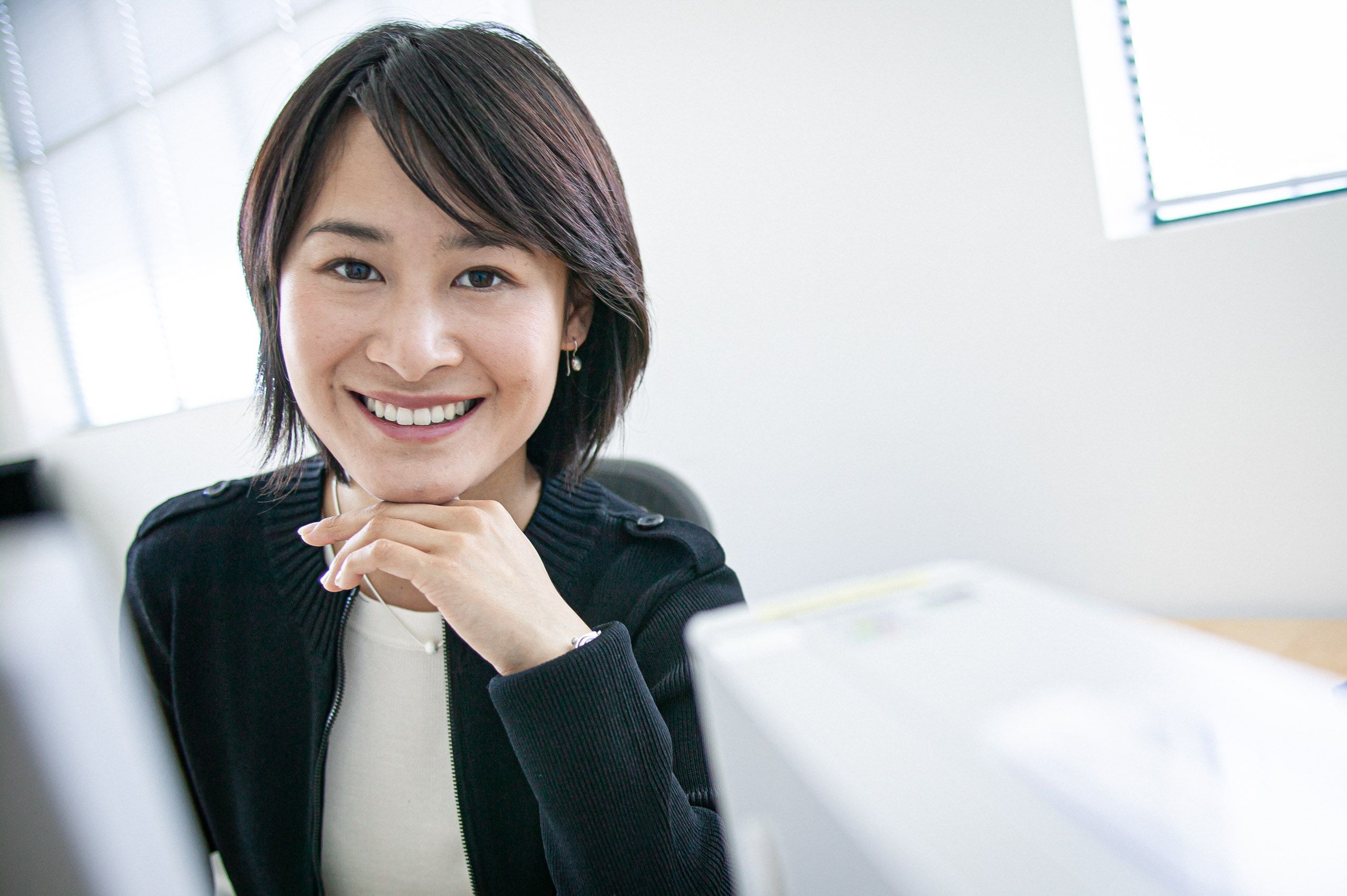 Woman Smiling at Desk