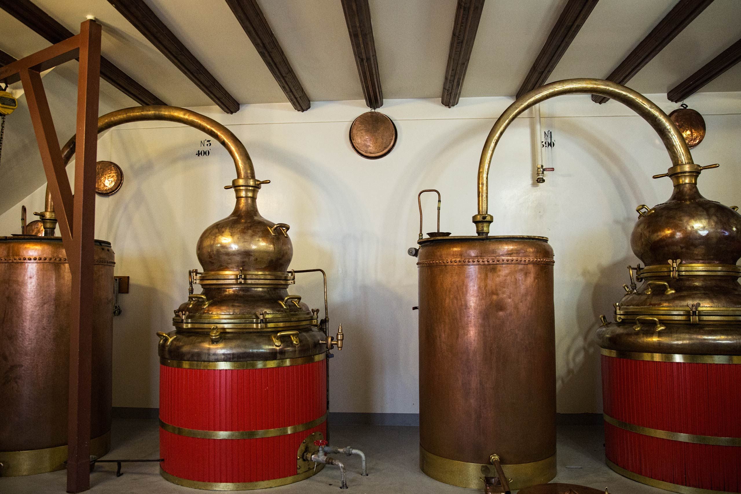 A wide photo of the old, sixth generation copper distillery located at Distillery Armand Guy, Photos of the mysterious spirit, absinthe, wormwood, located at Distillery Armand GUY in Pontarlier, France. This was a passion project and an amazing adventure into the world of absinthe, especially as on location photographer & location commercial photographer. Photo was shot with a shallow depth of field and selective focus. Old Copper Distillery at Distillery Armand GUY