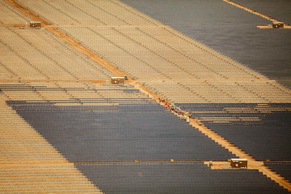 An graphic aerial photo of a huge solar farm in the midst of the solar panels being installed. This project was shooting a solar farm near El Centro, California, which is located right on the Mexico border. It will provide good clean, off the grid, green energy for many areas in southern California. As an industrial photographer, on location photographer & location commercial photographer this project was superb! Aerial View of Solar Panels Installation