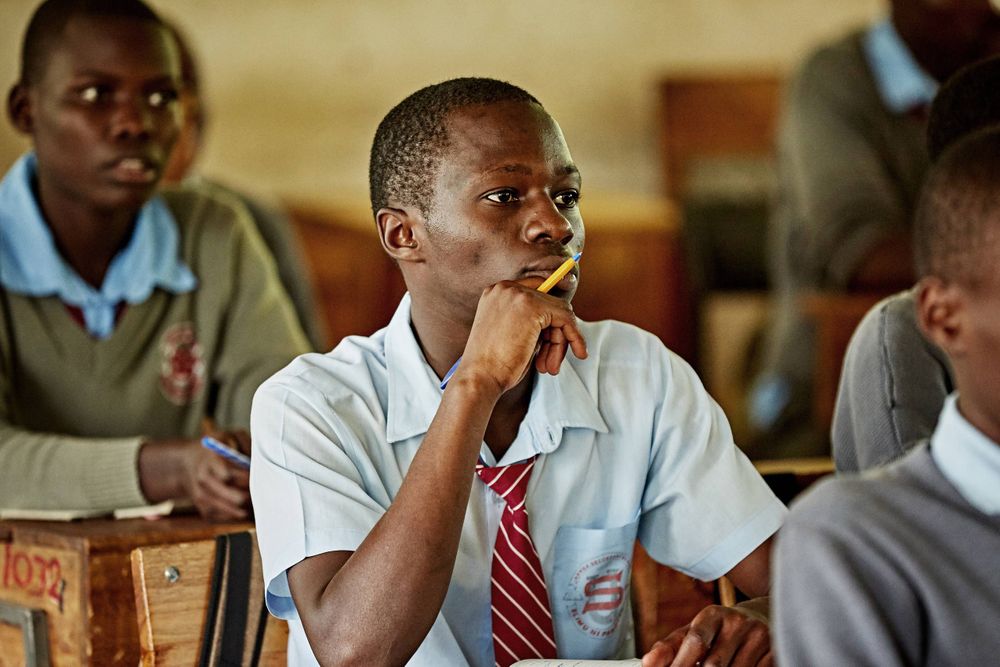 A male student in a classroom listening to a lecture. MaleStudying.jpg