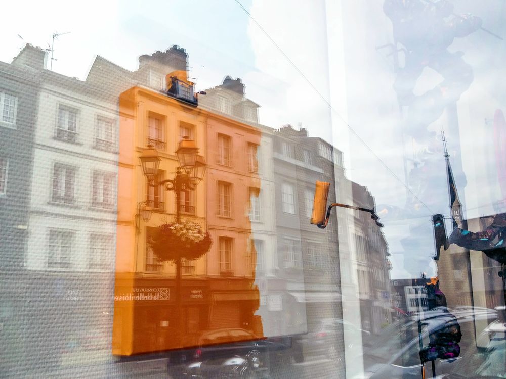 Painting a display case, inside a window, with the reflection of the building across the street. Rouen, France. If this was a composite image, I could understand, but it is not.