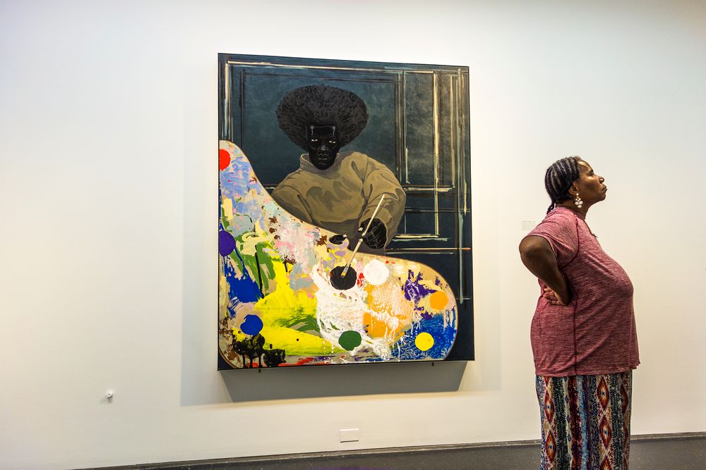 A great painter with great museum attendance. Chicago. A black woman with a Kerry James Marshall painting.