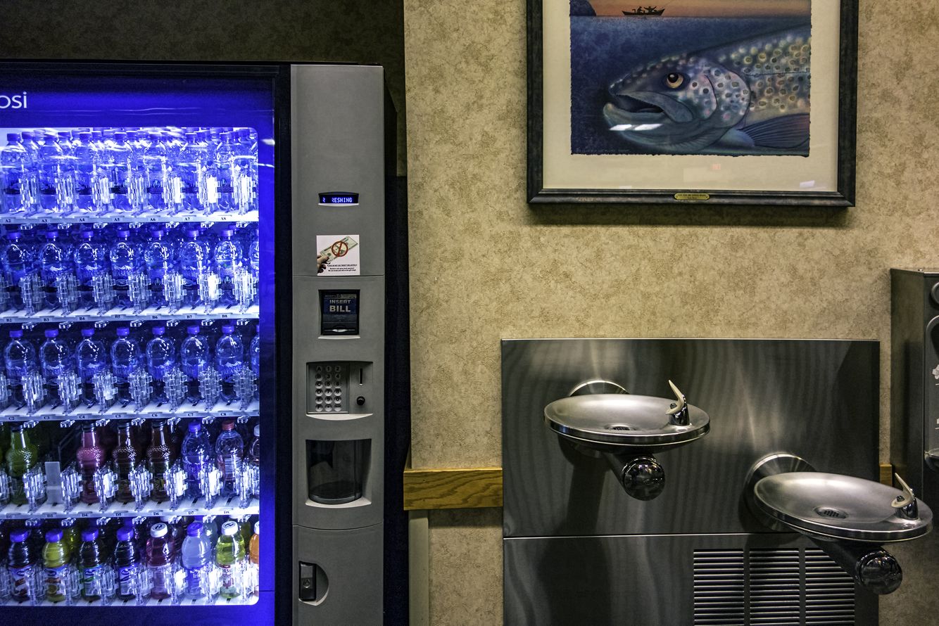 The Buddhist saying is 'Selling water by the river.' It seems to fit. Bozeman, Montana. A water vending machine next to a drinking fountain.