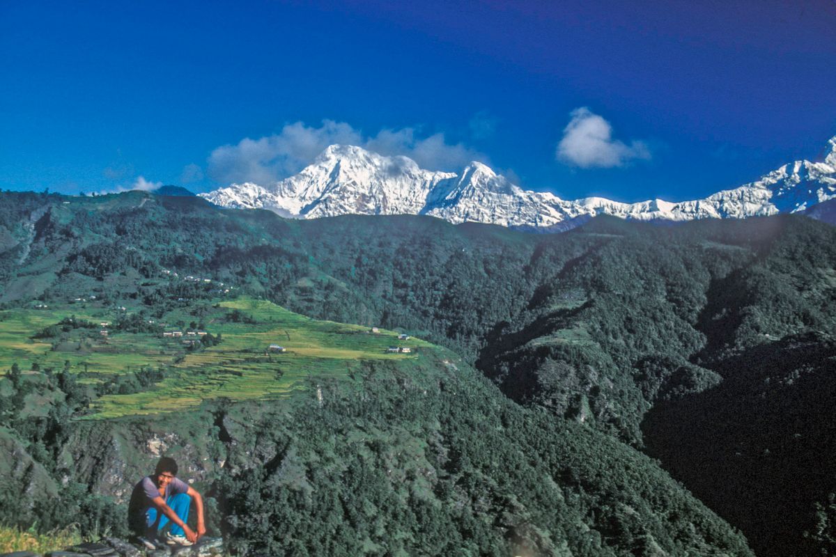 Almost the only time he sat down while on a training climb with the photographer. Pasang Sherpa with The  Annapurnas on the horizon.