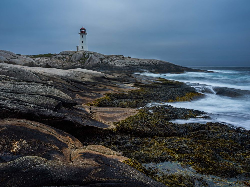 nova_scotia_peggys_cove_lighthouse_with_seaweed_sunrise.jpg