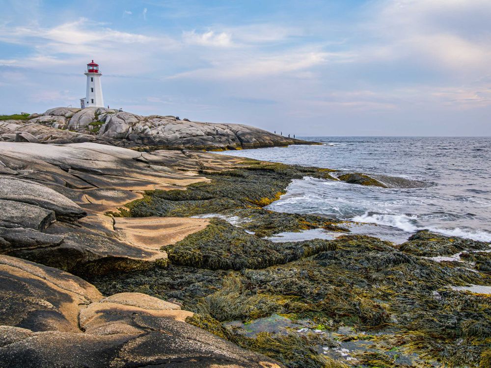 nova_scotia_peggys_cove_lighthouse_later_am_with_people.jpg