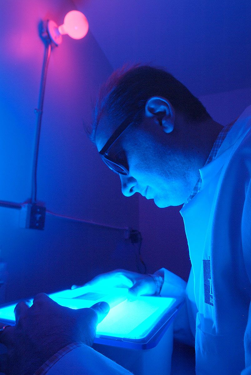 studying samples in a lab for Luca Technologies Tech in lab darkroom