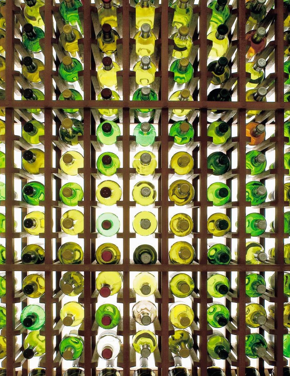 back lit wine bottles in a rack