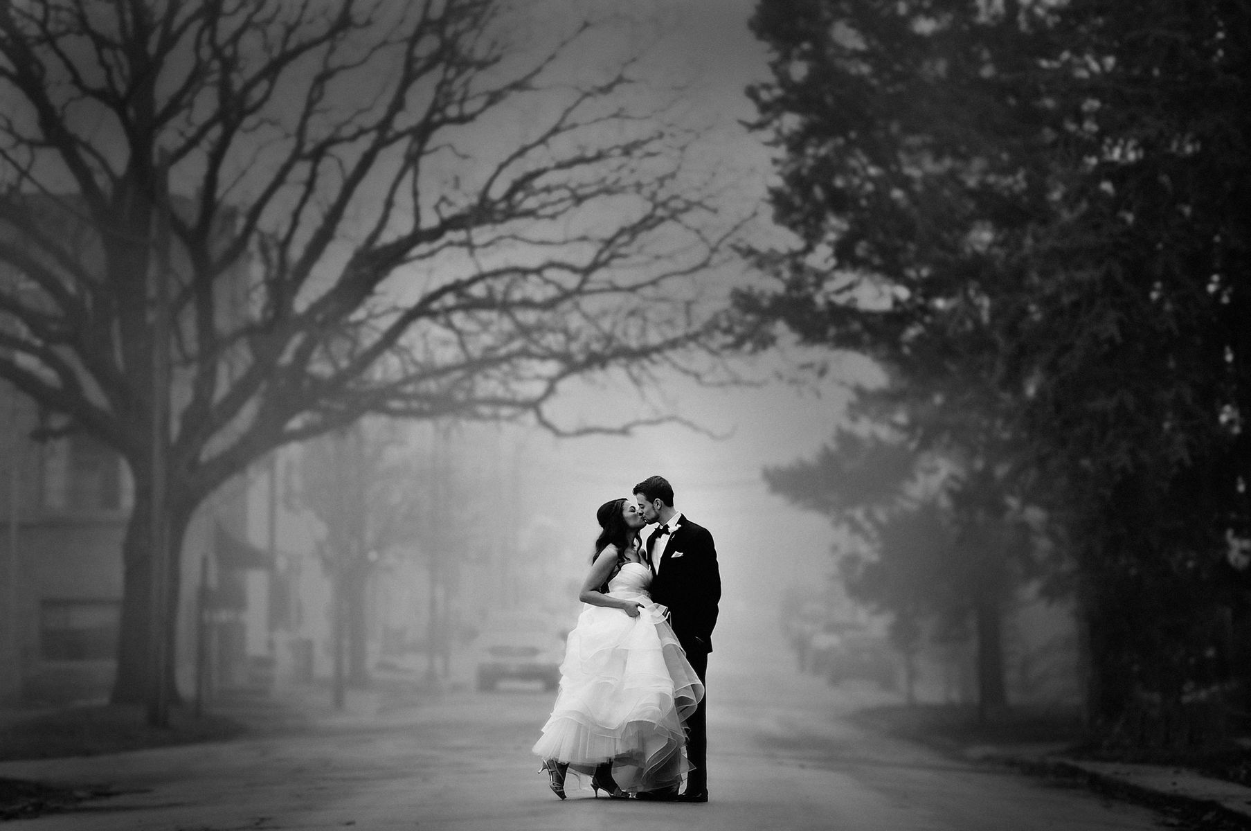 A beautiful winter wedding at Starline Factory Harvard IL. Instead of snow we had fog, I was so very happy when the couple allowed me to create this photo for them Wedding photo kiss by the Starline Factory Harvard IL