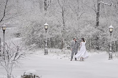 Bride and Groom dancing in the snow in the forest, Redfiels Estate in Glenview Winter wedding oudoor photo