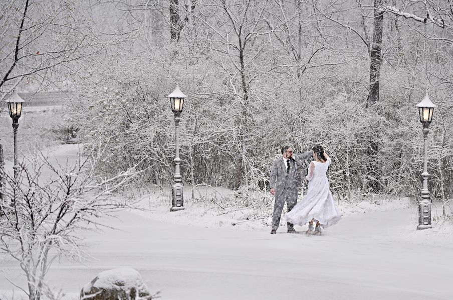 Bride and Groom dancing in the snow in the forest, Redfiels Estate in Glenview Winter wedding oudoor photo
