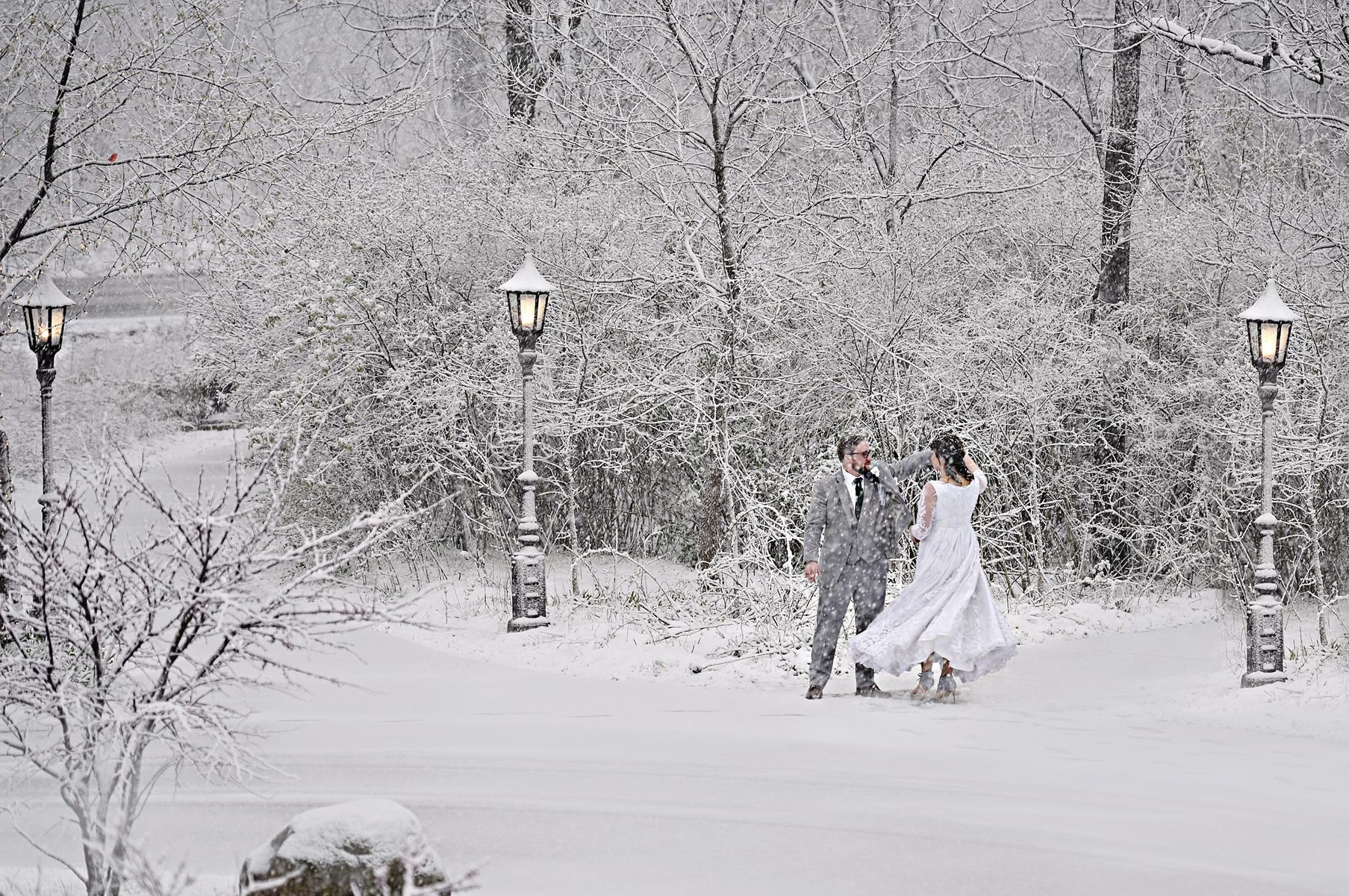 Bride and Groom dancing in the snow in the forest, Redfiels Estate in Glenview Winter wedding oudoor photo