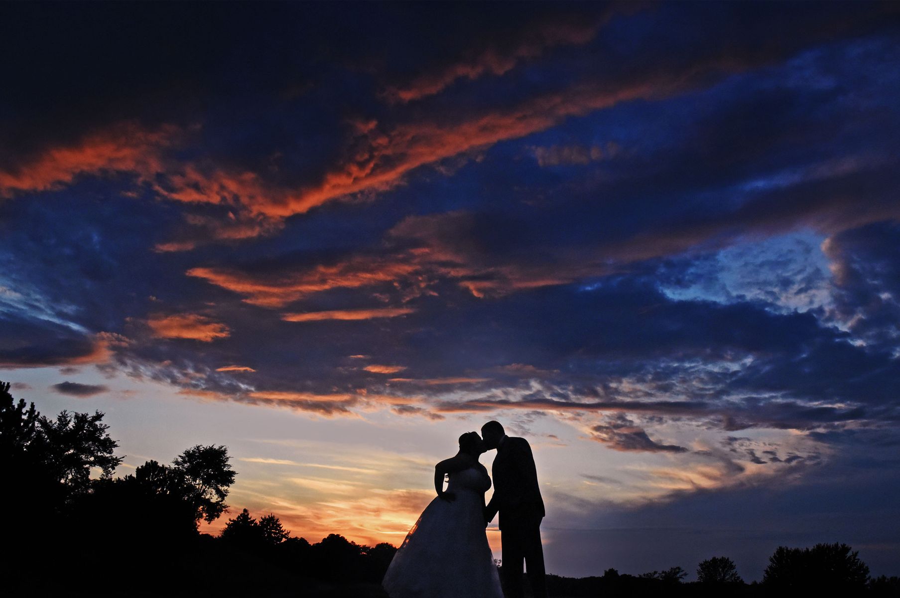 Sunset wedding photo with Bride and Groom kissing Chicago suburban wedding photographer