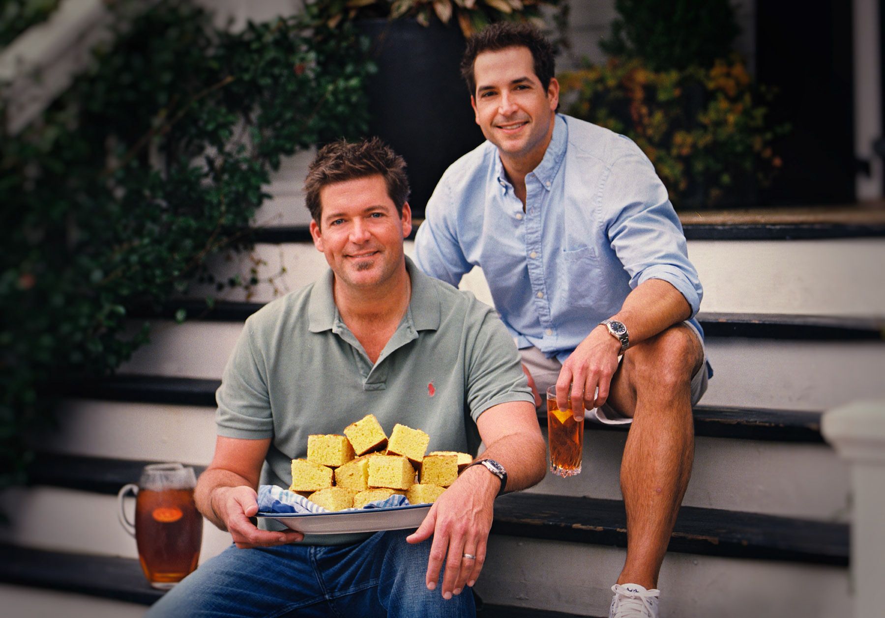 amie & Bobby Deen on porch of Paula Deen's Home with platter of cornbread and pitcher of sweet tea for Cookbook. "The deen Bros. Take it Easy"www.rkjacobs.comTop Food Photographer New York Seattle PortlandRobert Jacobs Photography ©2013 Jamie & Bobby Deen on porch of Paula Deen's Home with platter of cornbread and pitcher of sweet tea for Cookbook. "The deen Bros. Take it Easy"www.rkjacobs.comTop Food Photographer New York Seattle PortlandRobert Jacobs Photography ©2013