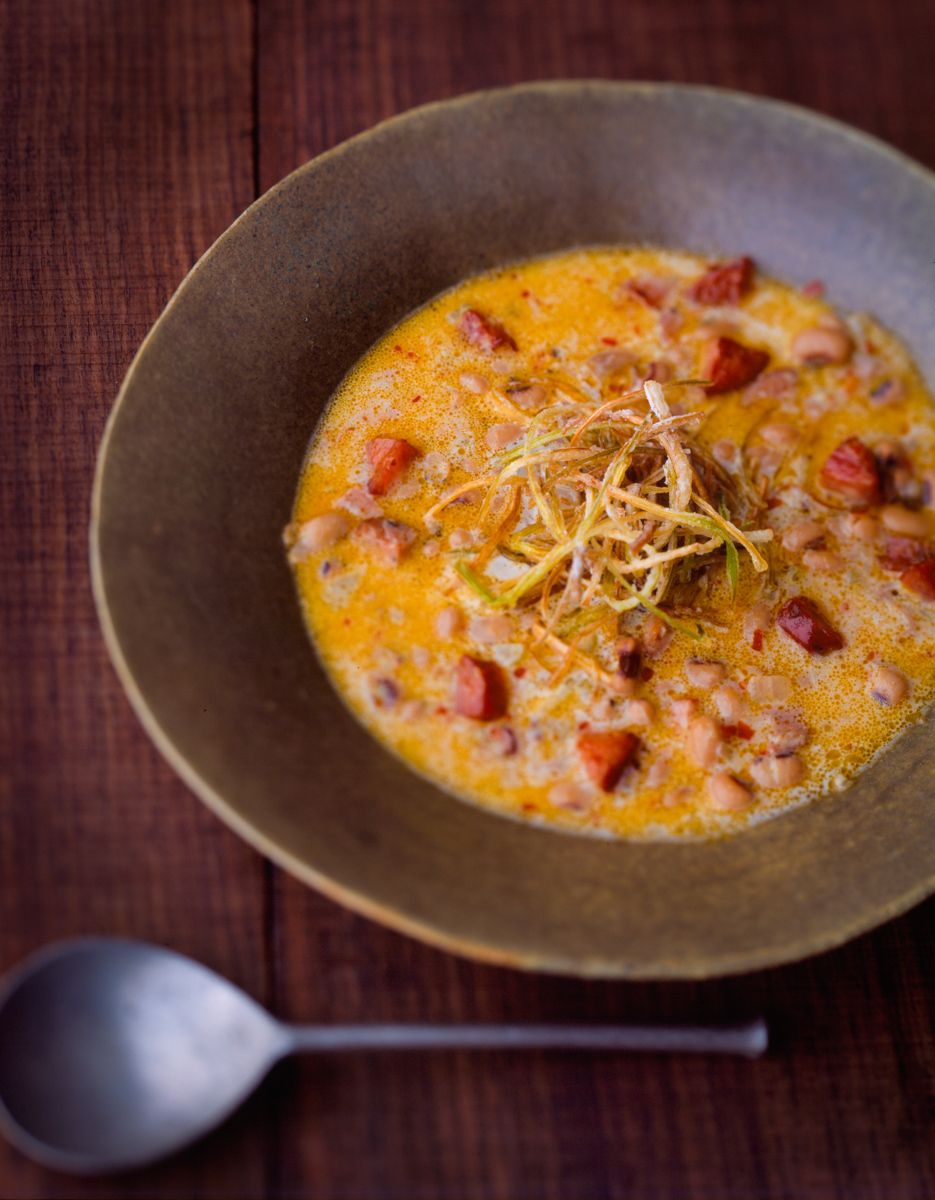 Andouille Sausage soup in rustic bowl on weathered wooden table  G.Garvin top food photographer New York Seattle Portland Robert Jacobs photography ©2013 www.rkjacobs.com