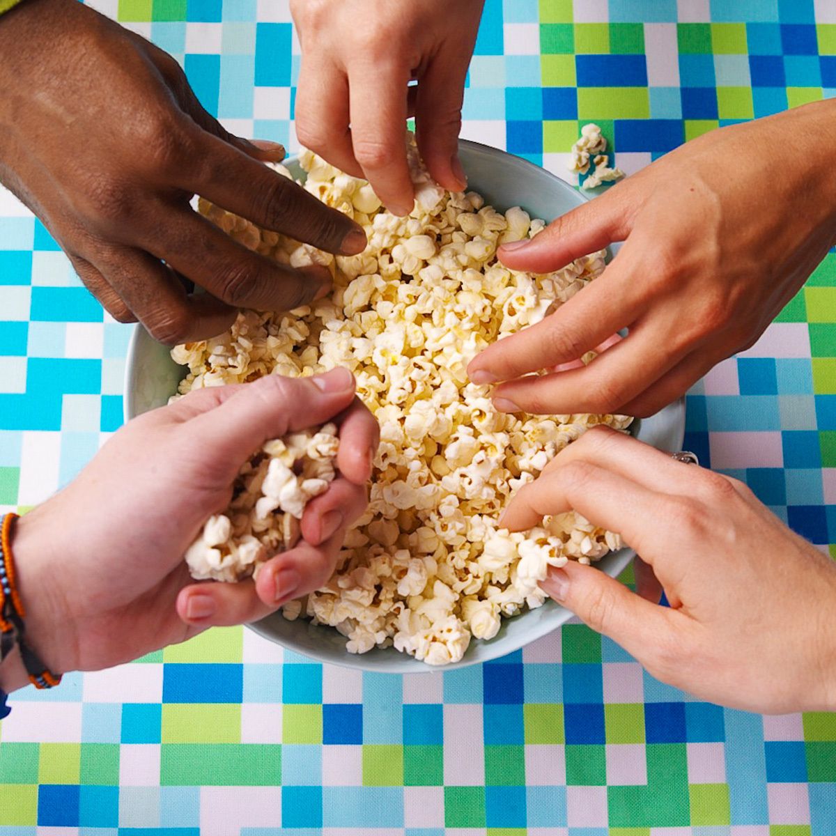 5 multi-racial hands holding popcorn on turquoise checked surface Food Network How to Boil Waterwww.rkjacobs.comTop Food Photographer New York Seattle PortlandRobert Jacobs Photography ©2013 5 multi-racial hands holding popcorn on turquoise checked surface Food Network How to boil Water Cookbookwww.rkjacobs.comTop Food Photographer New York Seattle PortlandRobert Jacobs Photography ©2013