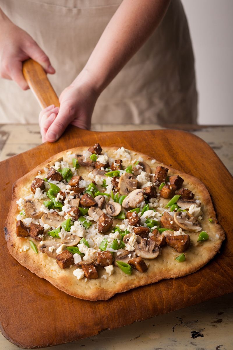 Woman sliding off wooden pizza paddle tofu mushroom  pizza www.rkjacobs.comTop Food Photographer New York Seattle PortlandRobert Jacobs Photography ©2013 Woman sliding off wooden pizza paddle tofu mushroom  pizza www.rkjacobs.comTop Food Photographer New York Seattle PortlandRobert Jacobs Photography ©2013