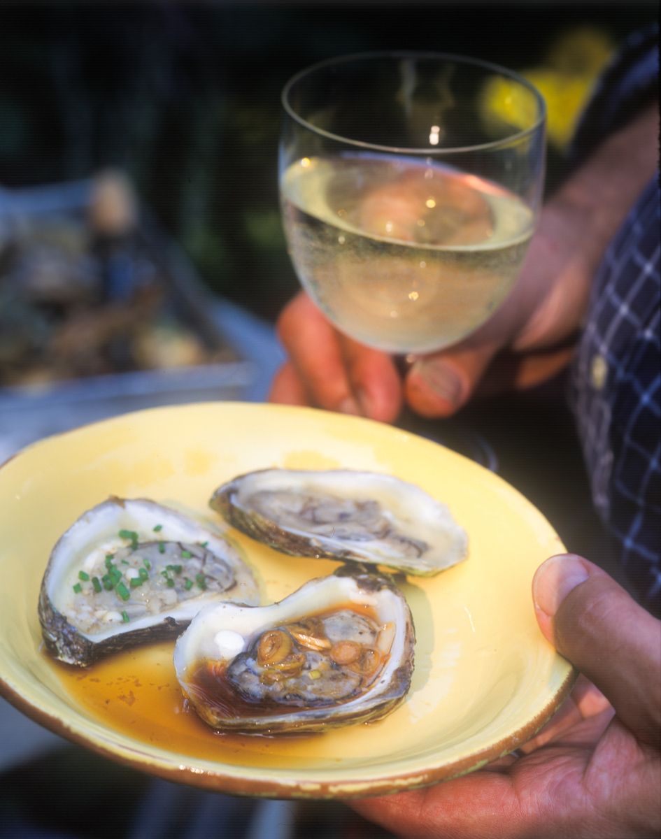 Man holding raw oyster on the half shell  on yellow plate with white wine  Food Network Kitchens "Grilling"www.rkjacobs.comTop Food Photographer New York Seattle PortlandRobert Jacobs Photography ©2013 Man holding raw oyster on the half shell  on yellow plate with white wine  Food Network Kitchens "Grilling"www.rkjacobs.comTop Food Photographer New York Seattle PortlandRobert Jacobs Photography ©2013