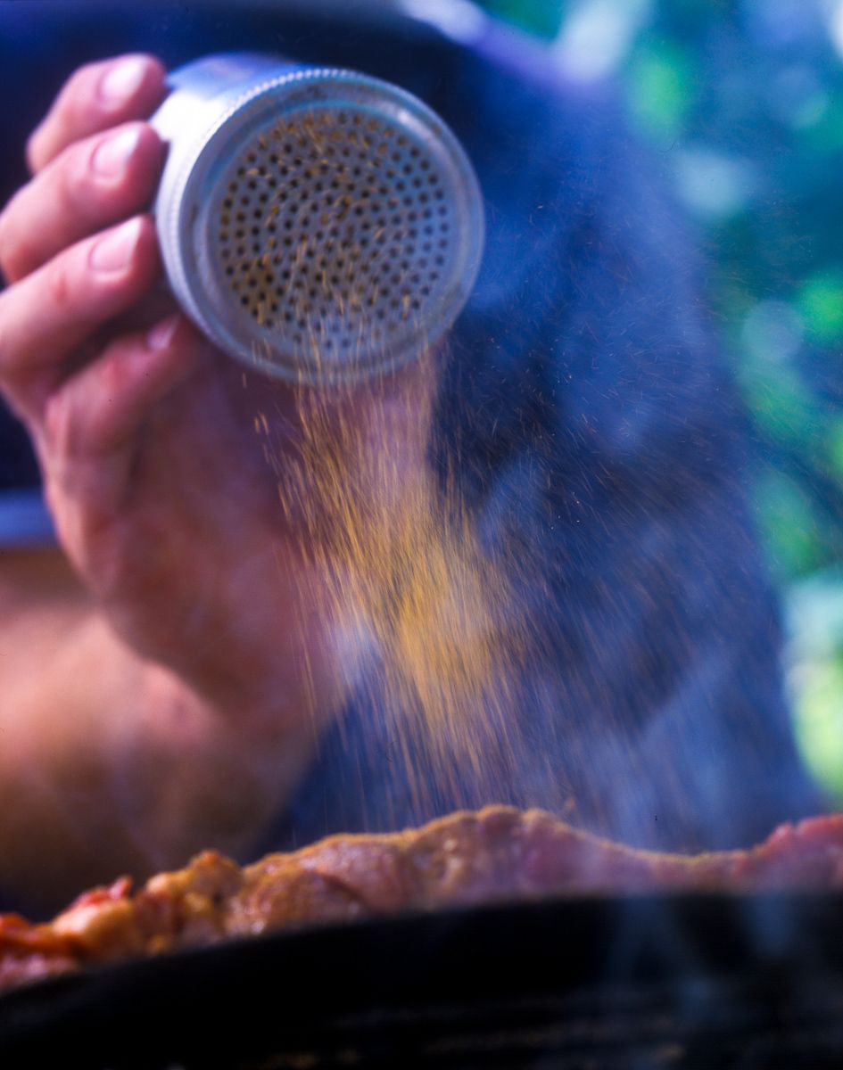 Spicy rub being sprinkled on steak over grill  Food Network Kitchens "Grilling"www.rkjacobs.comTop Food Photographer New York Seattle PortlandRobert Jacobs Photography ©2013 Spicy rub being sprinkled on steak over grill  Food Network Kitchens "Grilling"www.rkjacobs.comTop Food Photographer New York Seattle PortlandRobert Jacobs Photography ©2013
