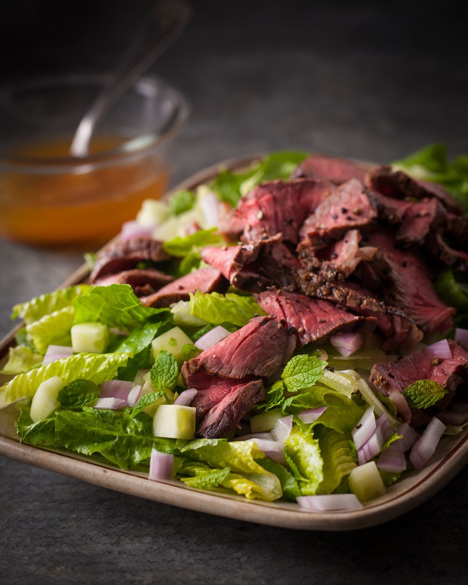 Sliced steak salad with dressing , london broil, romaine lettucewww.rkjacobs.comhttp://markbittman.com/Robert Jacobs Photography ©2013New York Times