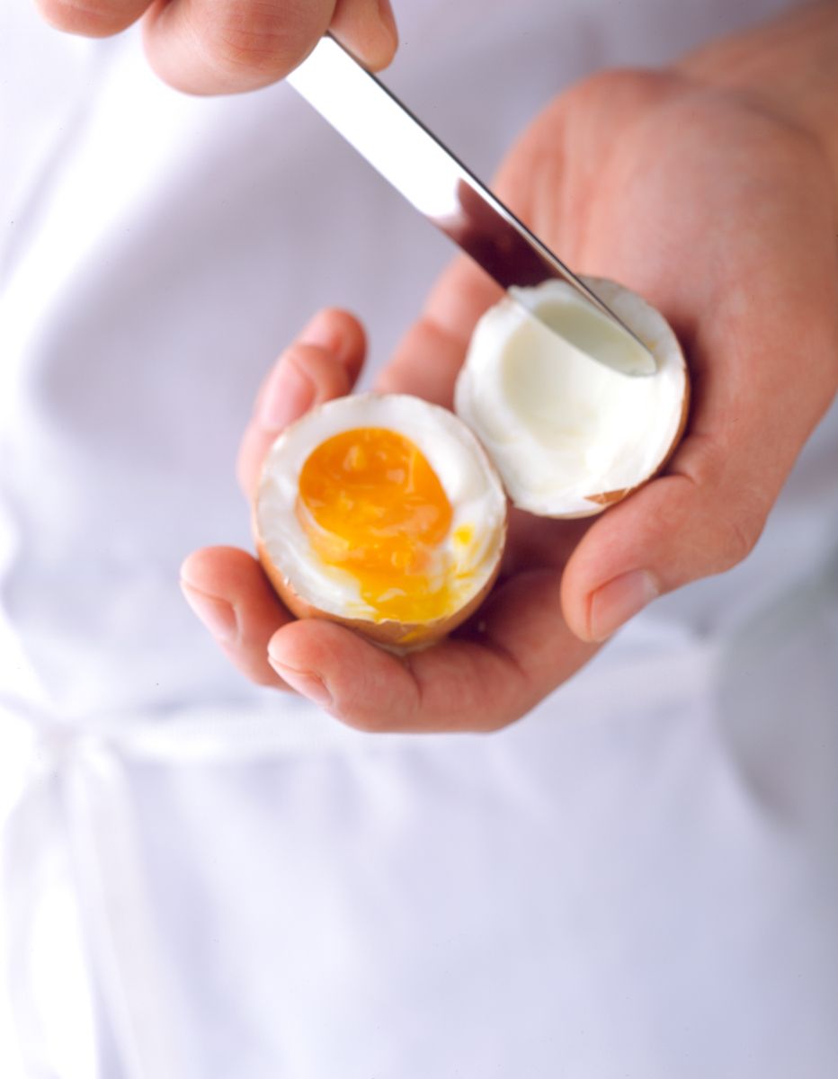 Man removing soft boiled egg from shell with hand and knife Food Network Kitchens "How To boil Water" cookbookwww.rkjacobs.comTop Food Photographer New York Seattle PortlandRobert Jacobs Photography ©2013 Man removing soft boiled egg from shell with hand and knife Food Network Kitchens "How To boil Water" cookbookwww.rkjacobs.comTop Food Photographer New York Seattle PortlandRobert Jacobs Photography ©2013
