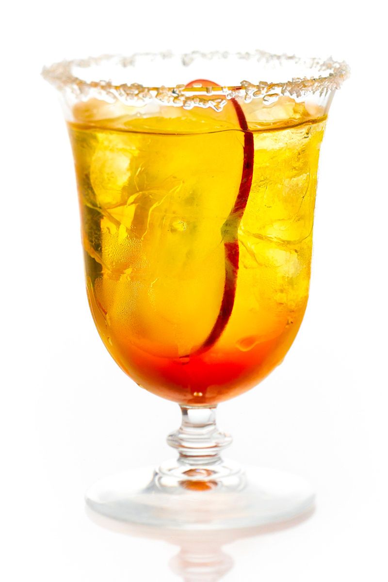 Iced apple drink in glass with sugar apple slice Iced apple drink in glass with sugar apple slice