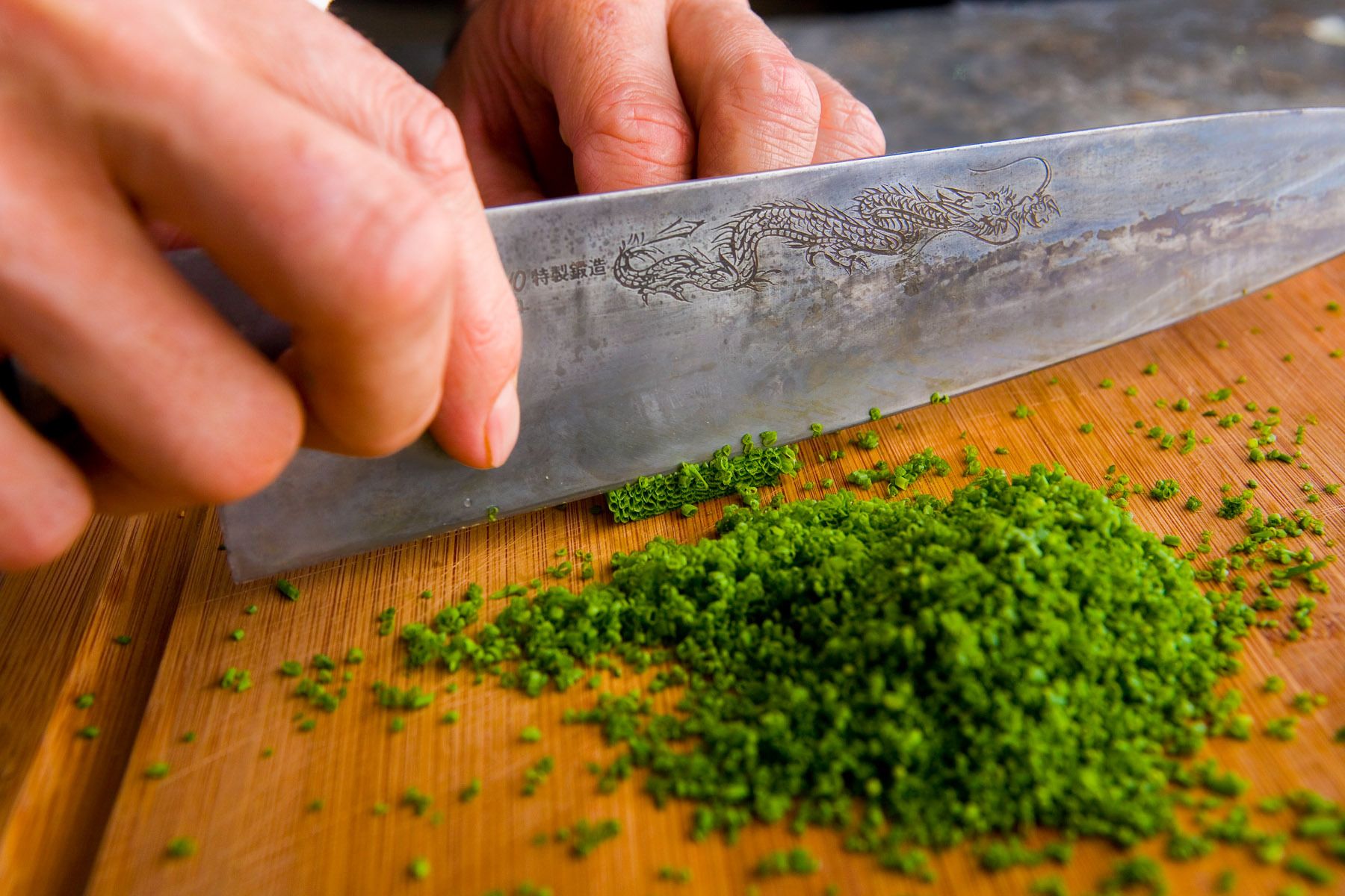 Rocco Disprito holding dragon steel knife cutting chiveswww.rkjacobs.comTop Food Photographer New York Seattle PortlandRobert Jacobs Photography ©2013 Rocco Disprito holding dragon steel knife cutting chiveswww.rkjacobs.comTop Food Photographer New York Seattle PortlandRobert Jacobs Photography ©2013